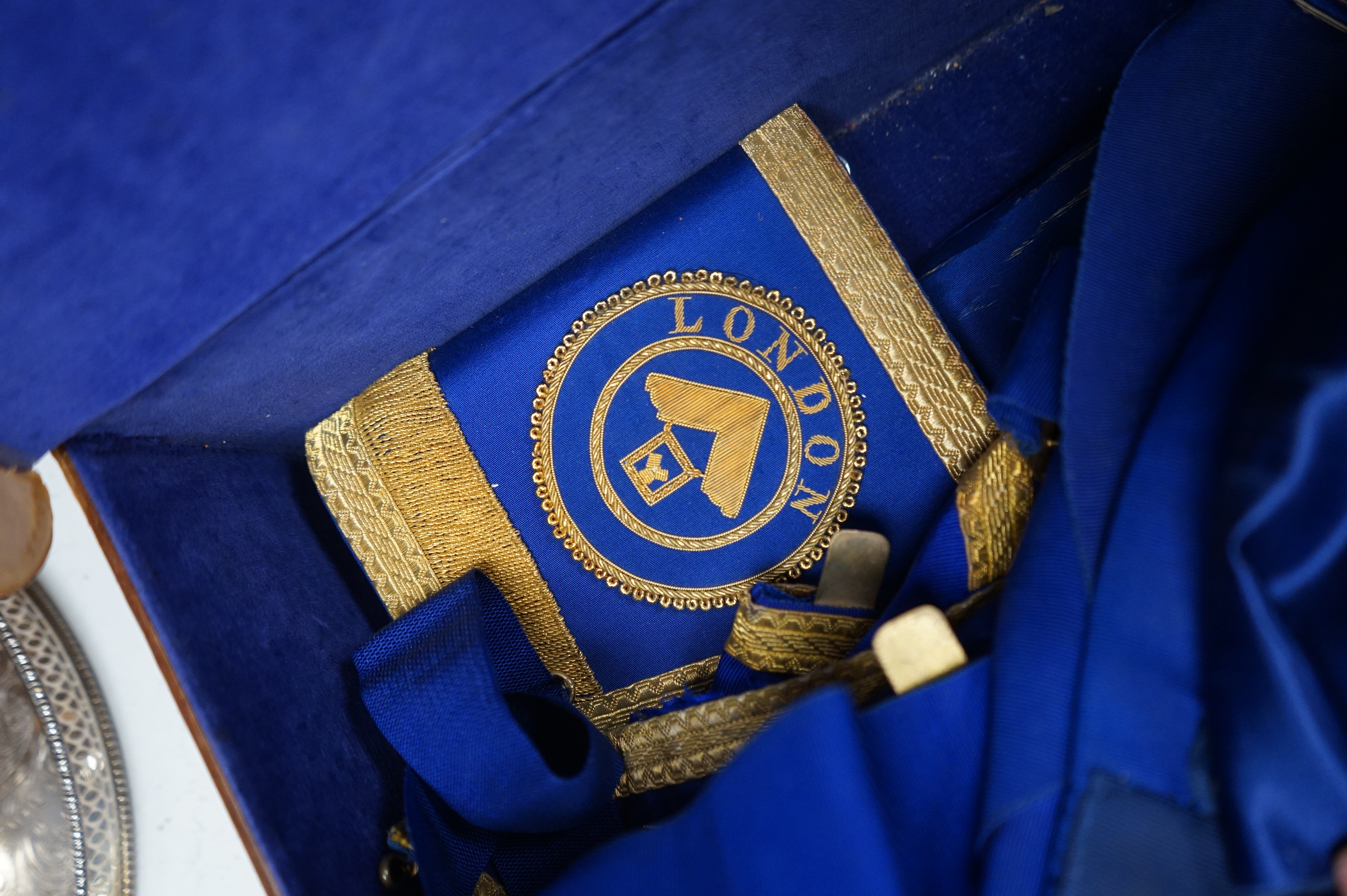 A suitcase containing Masonic related items including apron, sash etc. Condition - fair to good